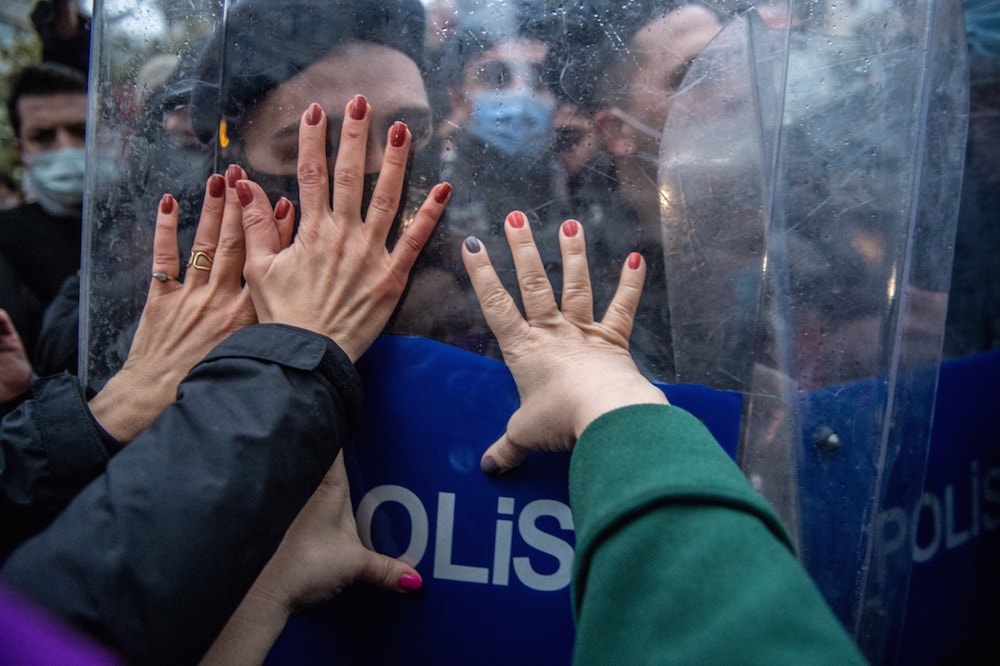 Police officers block protesters during a demonstration against Turkey's withdrawal from the Istanbul Convention, an international accord designed to protect women, in Istanbul, 20 March 2021, BULENT KILIC/AFP via Getty Images