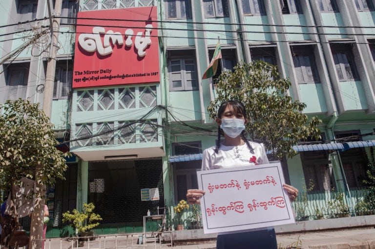 A government newspaper staff member holds a placard as her colleagues take to the streets to protest against the military coup and demand the release of Aung San Suu Kyi, Yangon, Myanmar, 11 February 2021, Santosh Krl/SOPA Images/LightRocket via Getty Images
