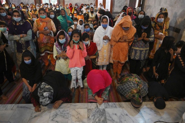 Christian devotees take part in a mass at a church in Lahore, Pakistan, 2 April 2021, ARIF ALI/AFP via Getty Images