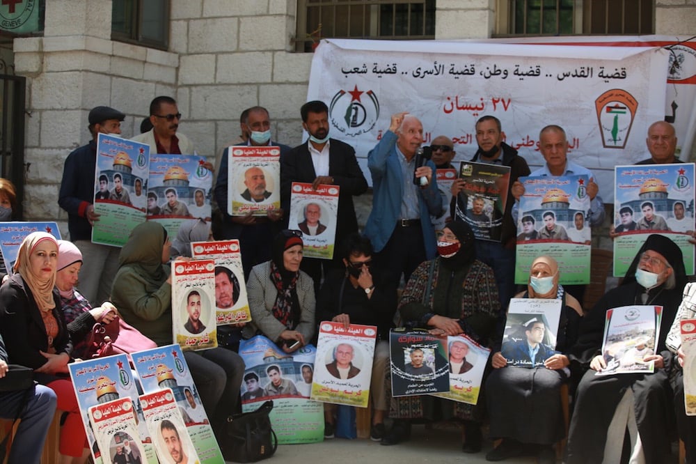 People gather in front of the International Committee of the Red Cross building to stage a demonstration in support of Palestinian prisoners in Israeli jails in Ramallah, West Bank, 27 April 2021, Issam Rimawi/Anadolu Agency via Getty Images