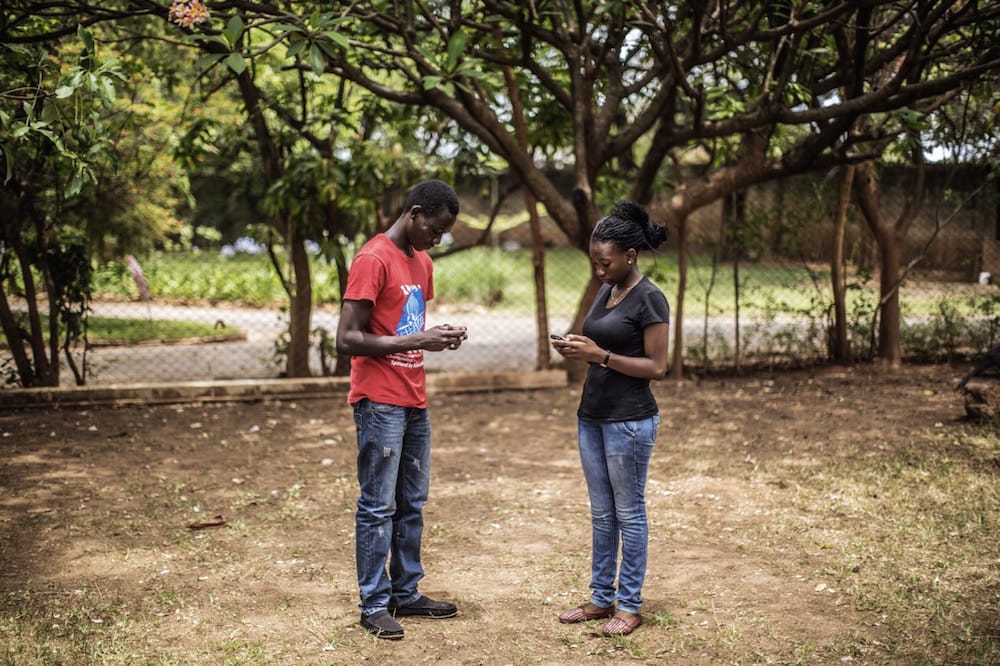 Youth activists use their cellular phones during a workshop on the use of communication devices to fight HIV and AIDS in Lusaka, Zambia, 29 November 2014, GIANLUIGI GUERCIA/AFP via Getty Images