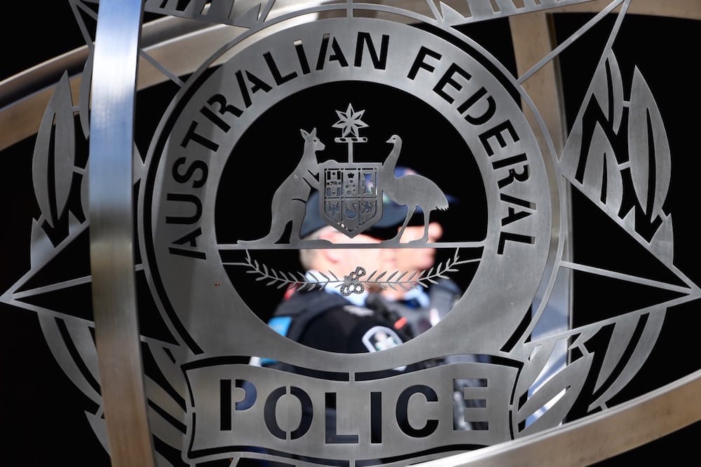 The AFP (Australian Federal Police) logo is seen un Canberra, Australia, 6 June 2019, during a press conference following the raid on News Corp and ABC, Getty Images