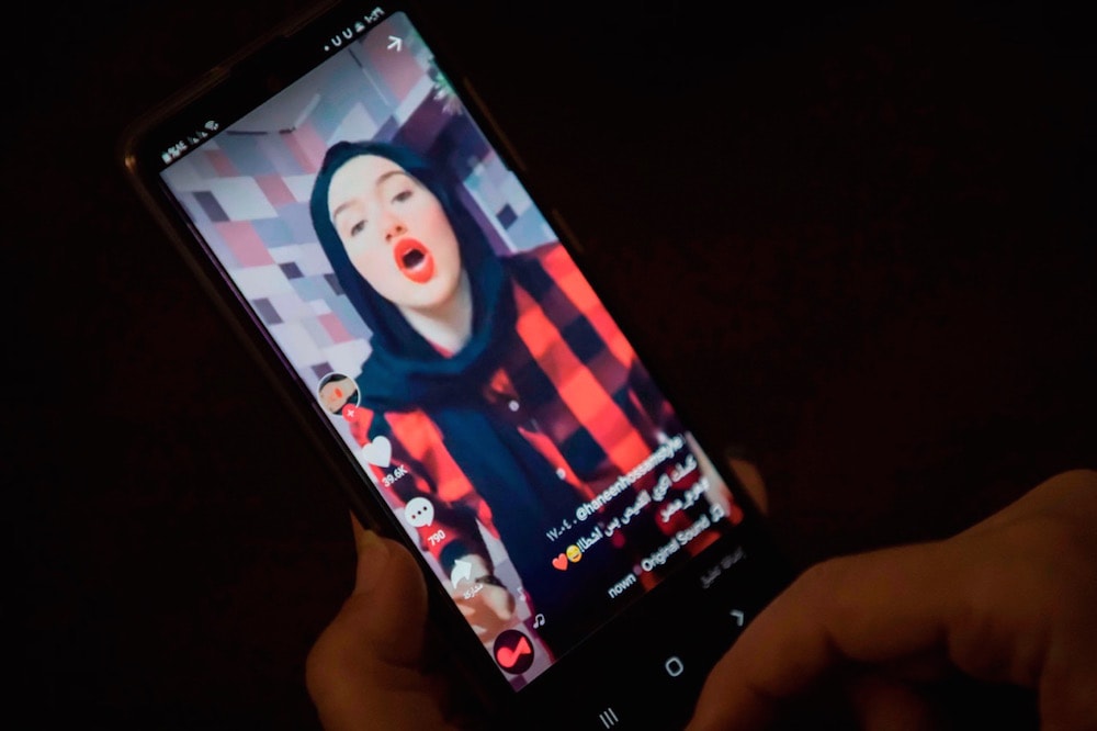 A woman watches a video of influencer Haneen Hossam, who is facing a human trafficking case for her TikTok posts, in Cairo, Egypt, 28 July 2020, KHALED DESOUKI/AFP via Getty Images