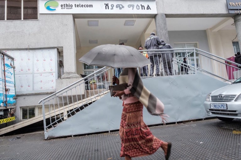 A woman walks in front of an office of Ethio telecom, till now Ethiopia's sole telecommunications provider, in Addis Ababa, 26 April 2021, EDUARDO SOTERAS/AFP via Getty Images