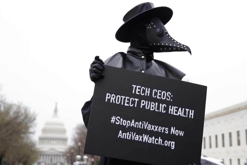 A person wearing a plague doctor mask protests outside the US Congress during a hearing on "Disinformation Nation: Social Media's Role in Promoting Extremism and Misinformation", Washington, DC, 25 March 2021, Alex Wong/Getty Images