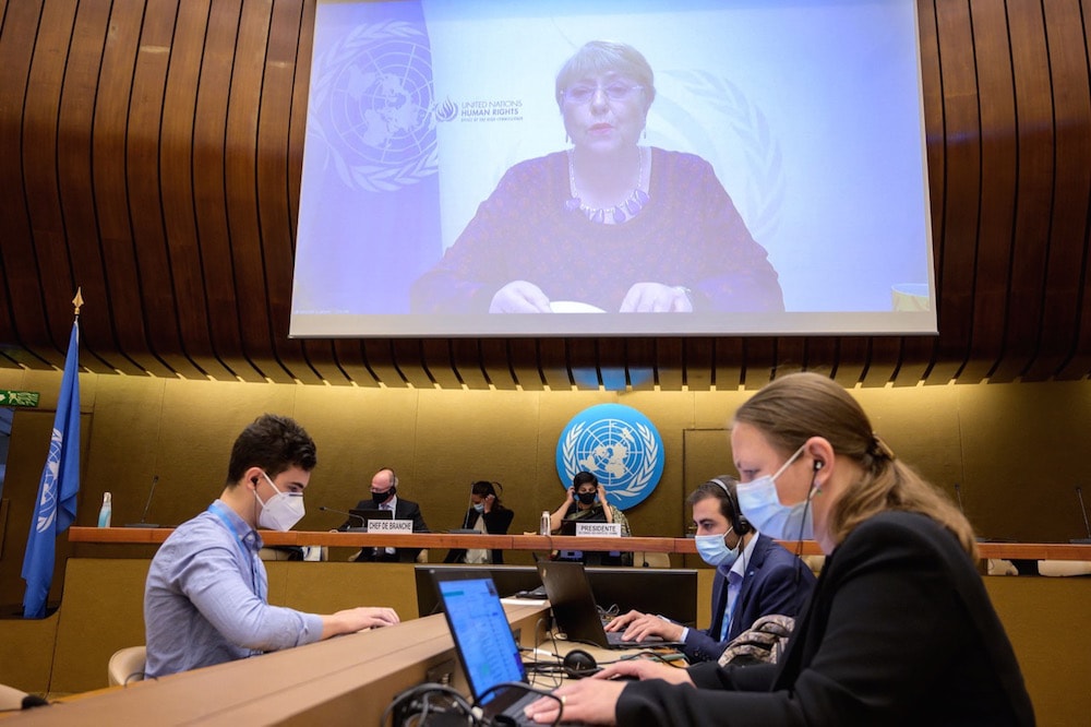 UN High Commissioner for Human Rights Michelle Bachelet is seen on a giant screen delivering her speech remotely at the opening of a UN Human Rights Council emergency meeting on occupied Palestinian territory including East Jerusalem, in Geneva, Switzerland, 27 May 2021, FABRICE COFFRINI/AFP via Getty Images