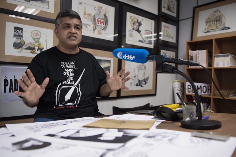 Malaysian cartoonist Zunar speaks with Agence France Presse (AFP) at his office in Kuala Lumpur, 13 April 2015, MOHD RASFAN/AFP via Getty Images