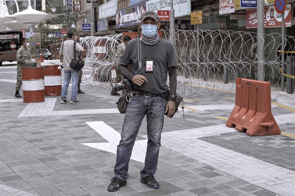 A photojournalist working for a foreign news agency poses for a portrait while reporting amidst the COVID-19 outbreak, Kuala Lumpur, Malaysia, 7 April 2020, Rahman Roslan/Getty Images