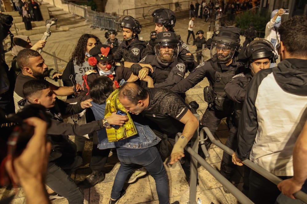 Israeli security forces forcefully push out Palestinian protesters near a barrier blocking access, outside the Damascus Gate in Jerusalem's Old City, 25 April 2021, AHMAD GHARABLI/AFP via Getty Images