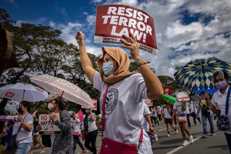 People take part in a protest against the Terrorism Act and the government's response to COVID-19, in Quezon City, Metro Manila, Philippines, 30 November 2020, Ezra Acayan/Getty Images