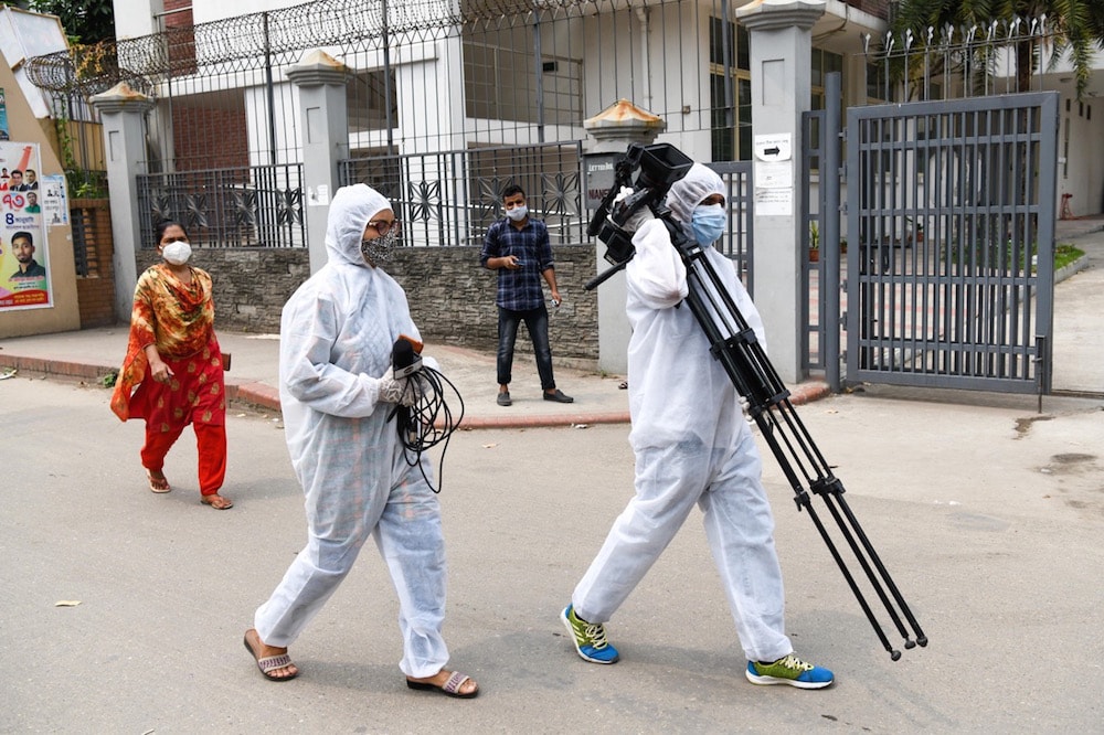 Journalists wearing protective suits as a preventive measure against the spread of Covid-19, at the Mugda Medical College Hospital, Dhaka, Bangladesh, 10 April 2021, Piyas Biswas/SOPA Images/LightRocket via Getty Images