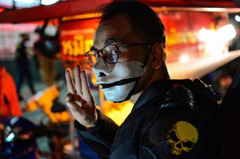 A protester wearing a mask gives the three-finger salute during a pro-democracy rally, in Bangkok, Thailand, 6 December 2020, MLADEN ANTONOV/AFP via Getty Images