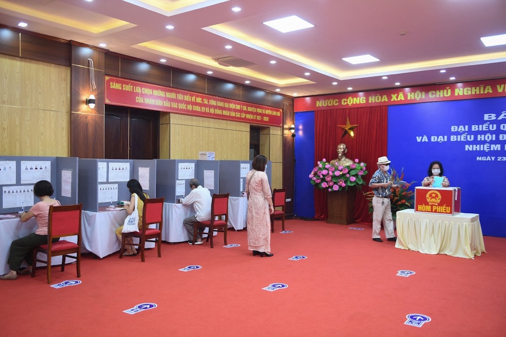 Hanoi, 23 May 2021. Local residents cast their ballots at a voting station as Vietnam holds legislative polls to elect a new 500-seat National Assembly, NHAC NGUYEN/AFP via Getty Images