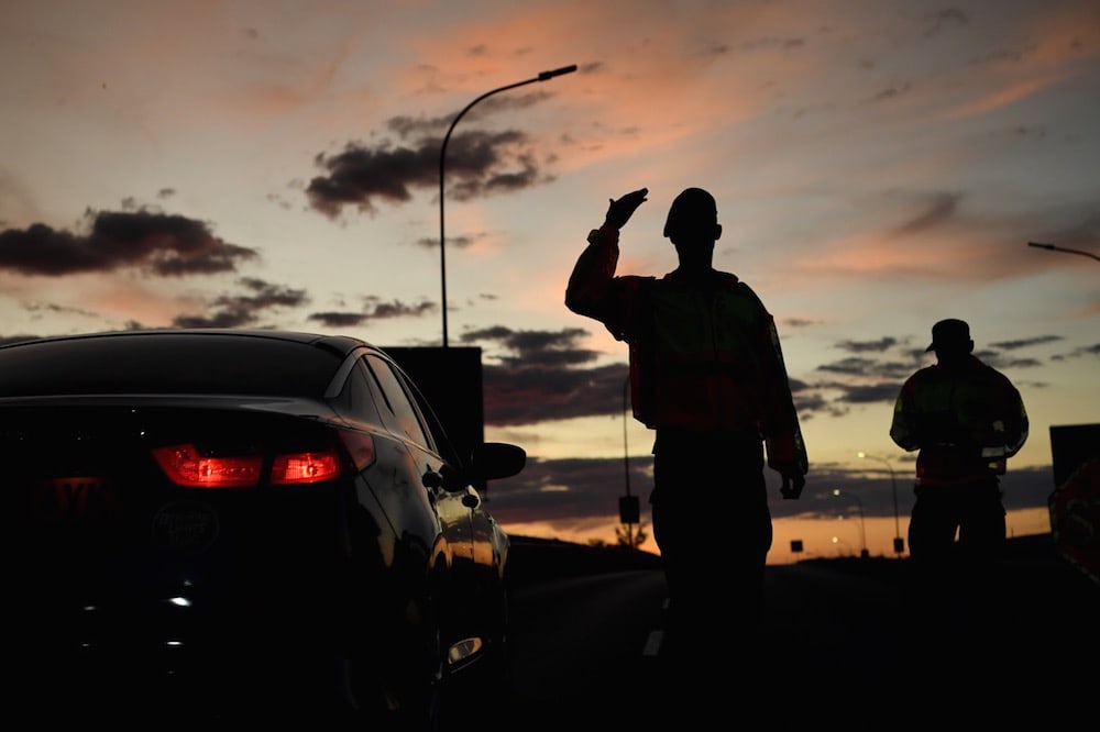 Military Police officers check the travel permits of travellers at a roadblock in Gaborone, Botswana, 5 April 2020, MONIRUL BHUIYAN/AFP via Getty Images