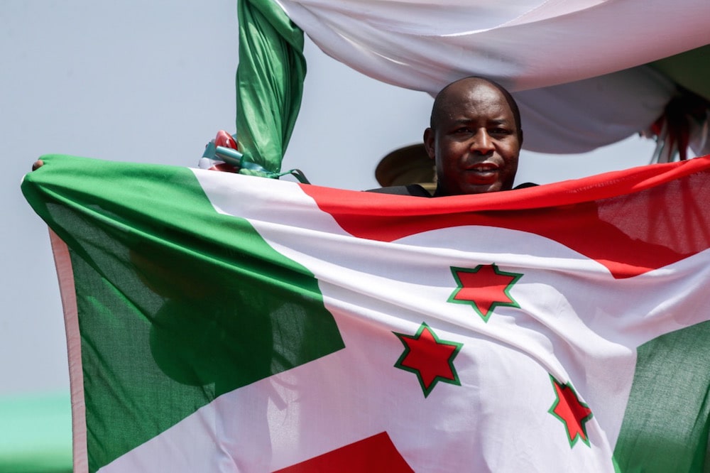 President Evariste Ndayishimiye holds up the national flag of Burundi at his swearing-in ceremony in Gitega, 18 June 2020, Evrard Ngendakumana/Xinhua via Getty