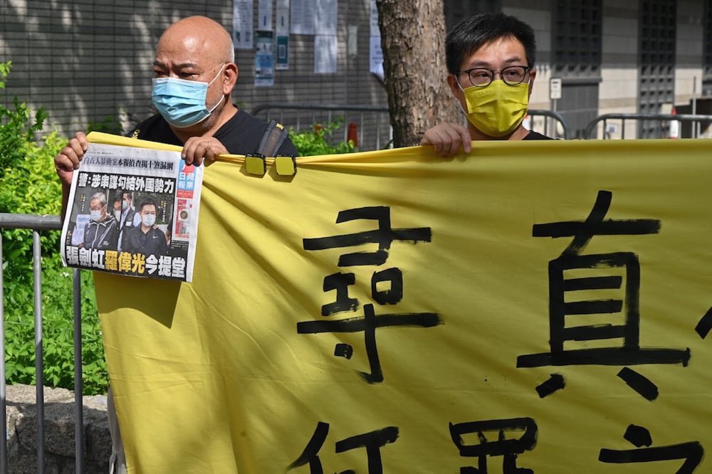 Supporters of "Apple Daily" protest outside the court, as two of the paper's executives face charges under the National Security Law, Hong Kong, 19 June 2021, PETER PARKS/AFP via Getty Images