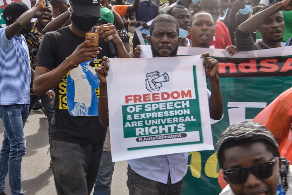 A protester holds a banner during a demonstration against bad governance and insecurity and the government's Twitter ban, in the Ojota district of Lagos, Nigeria, 12 June 2021, Olukayode Jaiyeola/NurPhoto via Getty Images