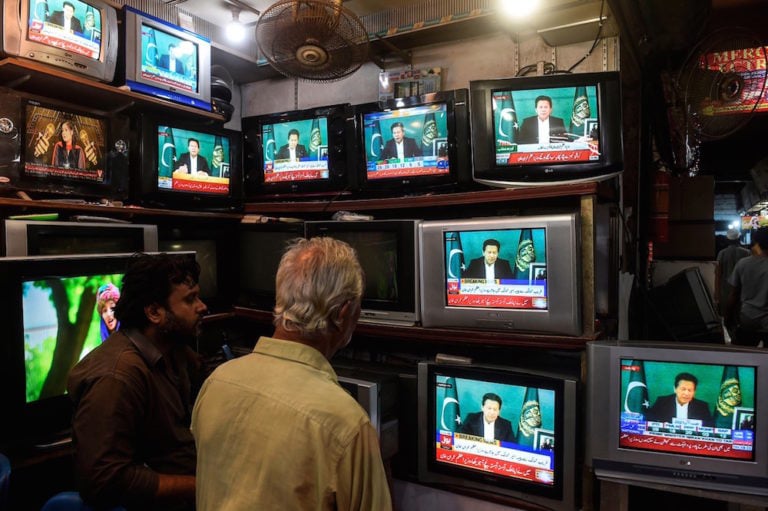 Shopkeepers listen to Prime Minister Imran Khan addressing the nation on television, in Karachi, Pakistan, 4 March 2021, ASIF HASSAN/AFP via Getty Images