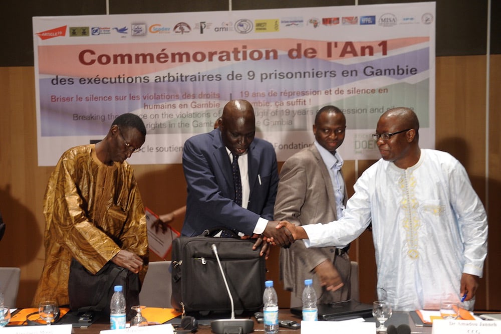 Dakar, Senegal, 23 August 2012. Senegalese journalist Madiambal Diagne (C) moderates a round-table discussion on human rights and freedom of expression in Gambia, SEYLLOU/AFP via Getty Images