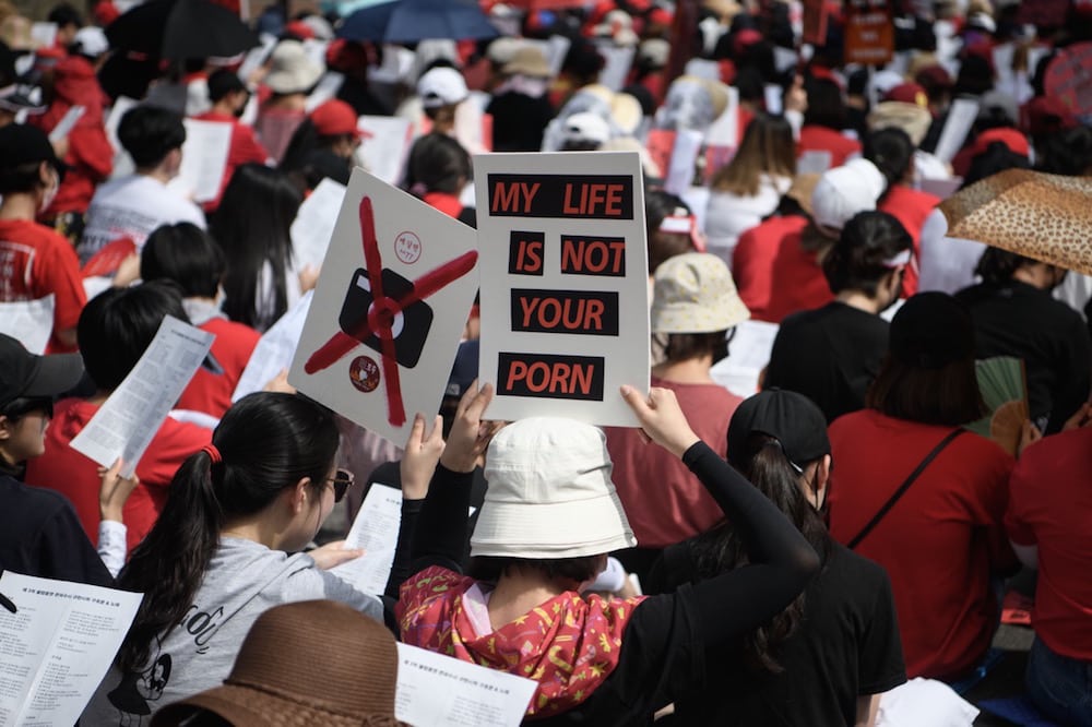 Female protesters call for South Korea's government to crack down on widespread spycam porn crimes, during a rally in Seoul, 7 July 2018, STR/AFP via Getty Images