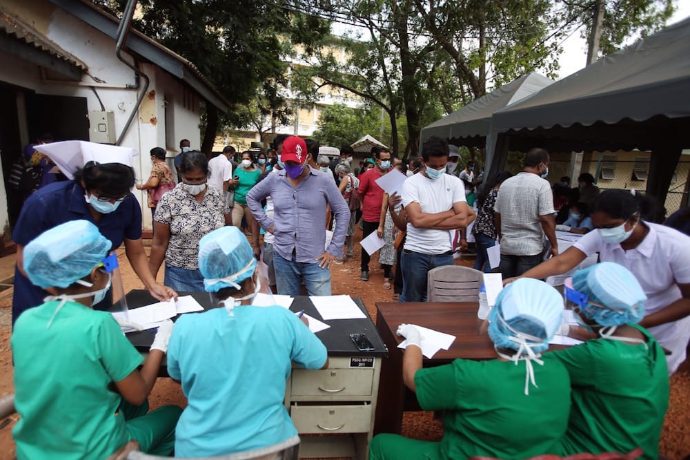 People queue up to register for coronavirus vaccines outside a hospital on the outskirts of Colombo, Sri Lanka, 20 February 2021, Xinhua/Ajith Perera via Getty Images