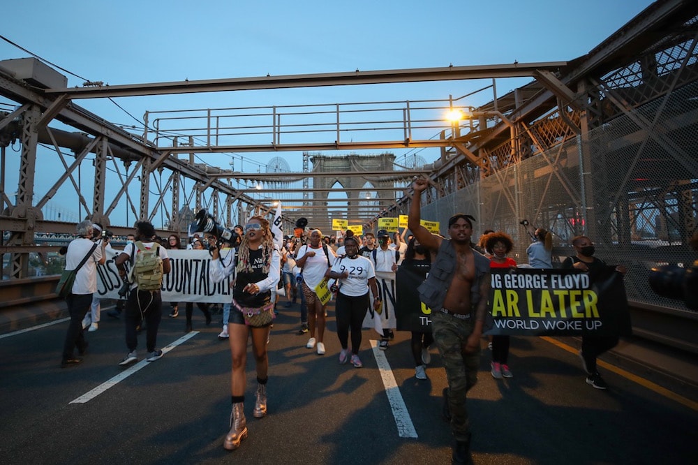 Black Lives Matter protesters march on the one-year anniversary of George Floyd's murder, crossing the Brooklyn Bridge to Manhattan, New York City, United States, 25 May 2021, Tayfun Coskun/Anadolu Agency via Getty Images