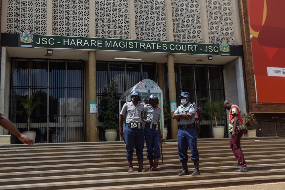 Police officers stand guard at the entrance to the Magistrate court in Harare, Zimbabwe, 6 April 2021, Tafadzwa Ufumeli/Getty Images