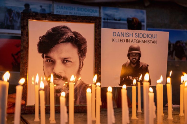 Lit candles are placed next to portraits of photojournalist Danish Siddiqui, during a vigil by the Press Club India (PCI) and the working news cameraman association (YWCA), New Delhi, India, 17 July 2021, Pradeep Gaur/SOPA Images/LightRocket via Getty Images