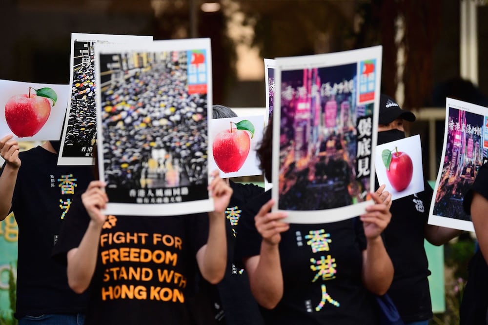 Activists hold copies of the shuttered Hong Kong paper "Apple Dailly", during a protest on the 100th anniversary of the Chinese Communist Party, in front of the Chinese Consulate in Los Angeles, California, 1 July 2021, FREDERIC J. BROWN/AFP via Getty Images