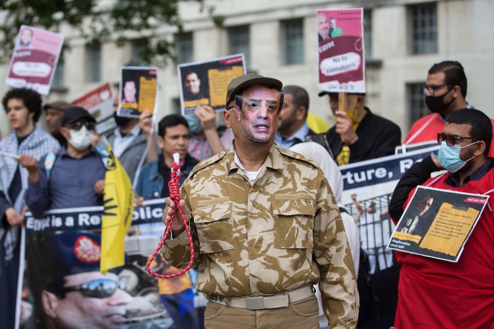 London, United Kingdom, 3 July 2021. A man wearing a mask featuring an image of General Abdel Fattah el-Sisi and holding a noose takes part in a demonstration against political executions in Egypt, Mark Kerrison/In Pictures via Getty Images