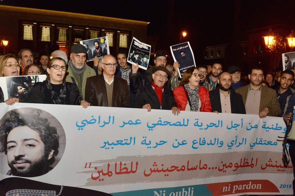Rabat, Morocco, 28 December 2019. Demonstrators shout slogans in support of detained Moroccan journalist Omar Radi, who was reportedly targeted using NSO spyware. STR/AFP via Getty Images