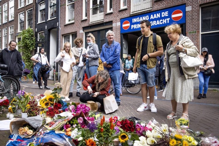 Bystanders lay flowers, candles and messages of support for journalist Peter R. de Vries, on Lange Leidsedwars street, central Amsterdam, Netherlands, 7 July 2021, KOEN VAN WEEL/ANP/AFP via Getty Images