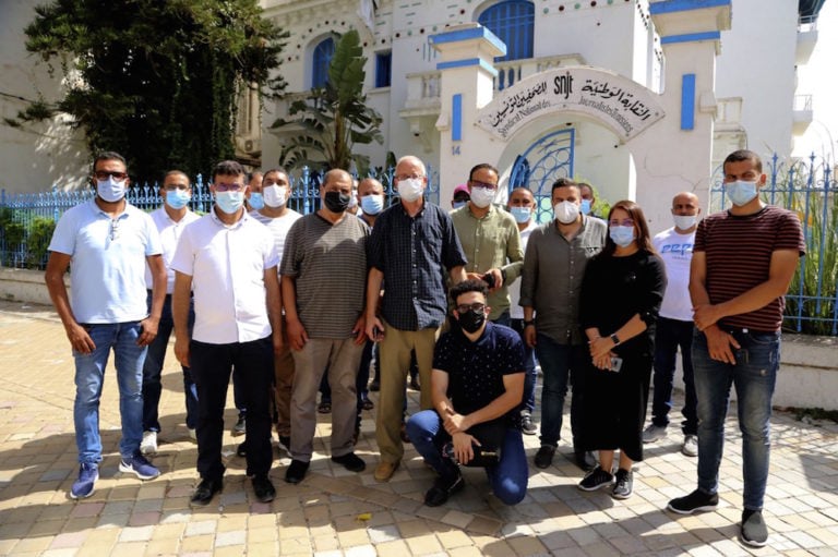 Al-Jazeera bureau chief Lotfi Hajji (C) and his team pose outside the headquarters of the national journalists' union (Syndicat National des Journalistes tunisiens, SNJT), in Tunis, 26 July 2021, after Tunisian police closed the broadcaster's offices. ANIS MILI/AFP via Getty Images