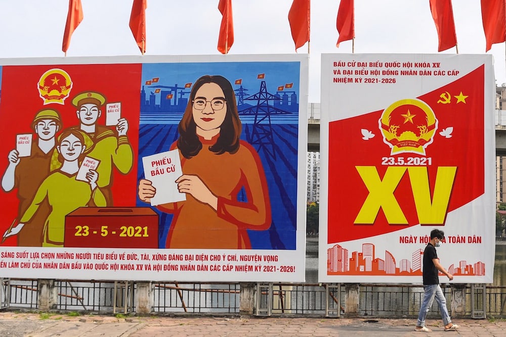 A man walks past billboards about the upcoming National Assembly and People's Councils elections in Hanoi, Vietnam, 19 May 2021, NHAC NGUYEN/AFP via Getty Images