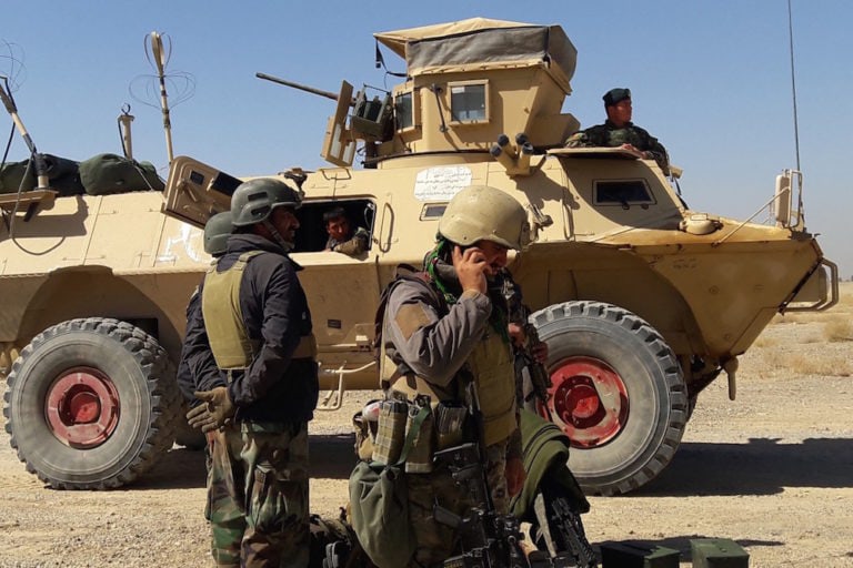 Afghan security forces stand near an armoured vehicle during ongoing fighting with Taliban fighters, in the Busharan area, near Lashkar Gah, Helmand province, 5 May 2021, SIFATULLAH ZAHIDI/AFP via Getty Images