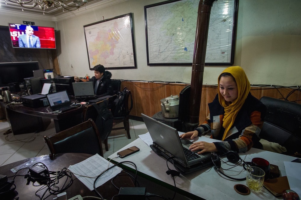 Journalist Freshta Farhang, who writes about women's issues for an online media outlet, sits at her desk in the newsroom, in Kabul, Afghanistan, 13 February 2019, Scott Peterson/Getty Images
