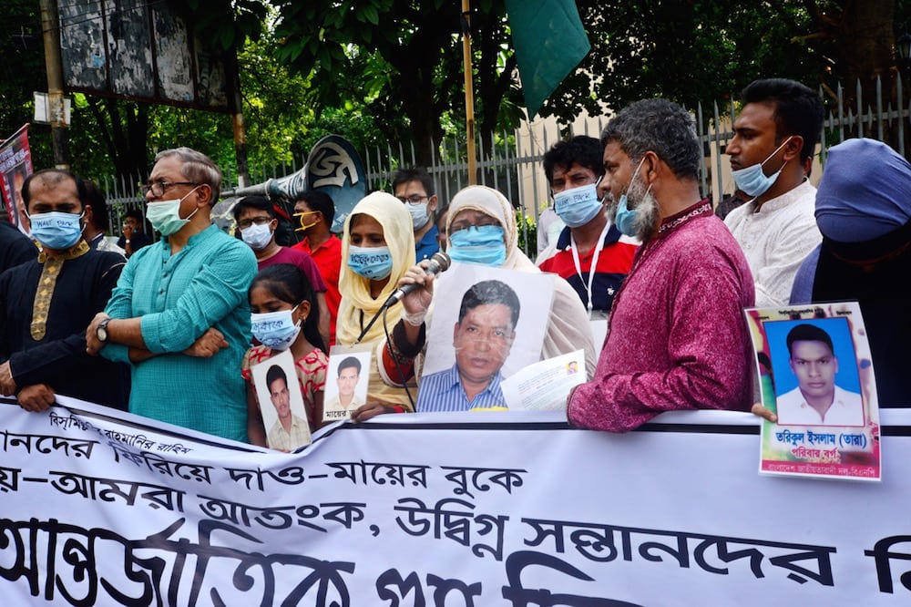 People hold portraits of their missing family members as they form a human chain ahead of the International Day of the Disappeared, in Dhaka, Bangladesh, 29 August 2020, Mamunur Rashid/NurPhoto