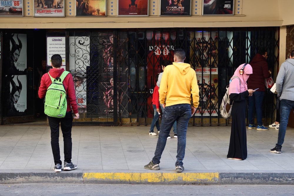 A woman checks her smartphone on a street in Alexandria, Egypt, 22 November 2019, Frédéric Soltan/Corbis via Getty Images
