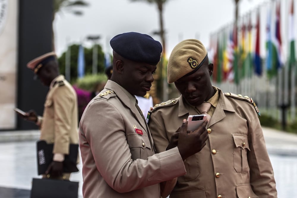Military officers from Ghana check a phone at the end of the first day of a conference gathering the Defence ministers and officials of 27 African and Arab countries, in Sharm el-Sheikh, Egypt, 24 March 2016, KHALED DESOUKI/AFP via Getty Images