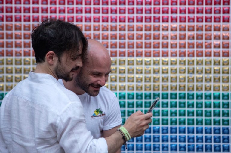 Two men look at a mobile phone during Milano Pride, an LGBTQ+ celebration, in Milan, Italy, 27 June 2019, Emanuele Cremaschi/Getty Images