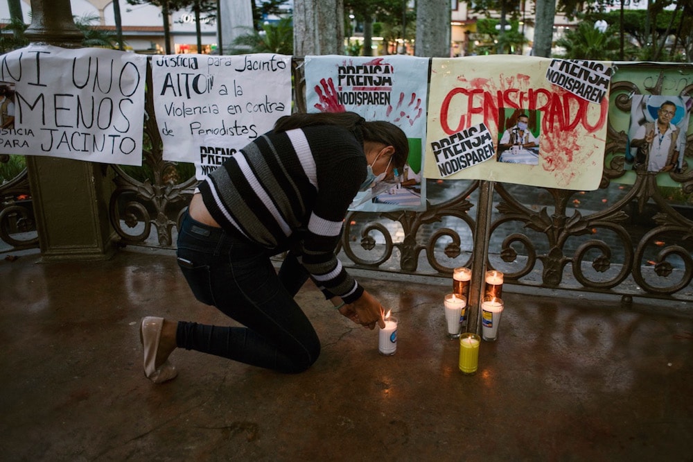 A woman lights a candle during a protest in demand for justice for the murder of Mexican journalist Jacinto Romero Flores, in Orizaba, Veracruz, 19 August 2021, VICTORIA RAZO/AFP via Getty Images