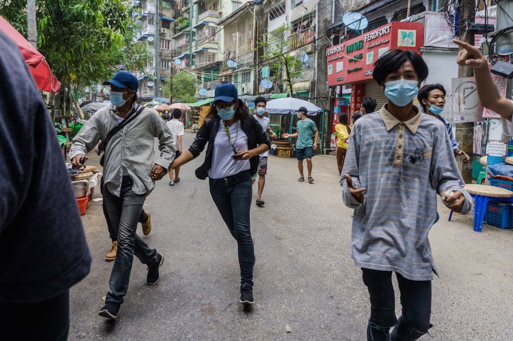 Protesters run from the police after taking part in a demonstration against the military coup, in Yangon's Sanchaung township, Myanmar, 27 April 2021, STR/AFP via Getty Images