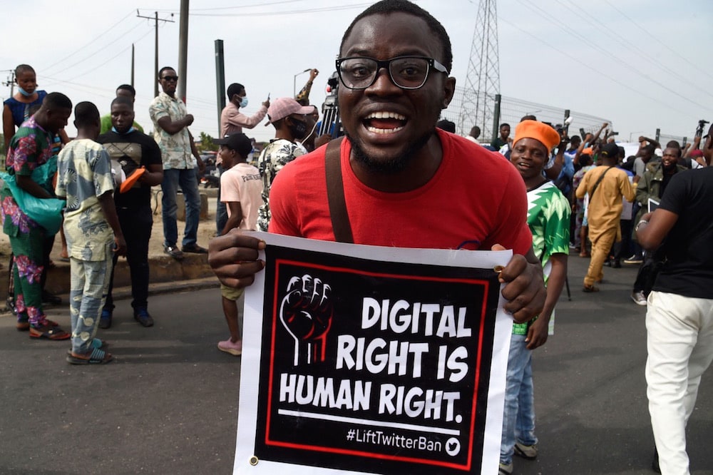 A man carries a banner during a demonstration against bad governance and insecurity and a ban on the social media platform Twitter, at Ojota in Lagos, Nigeria, 12 June 2021, PIUS UTOMI EKPEI/AFP via Getty Images