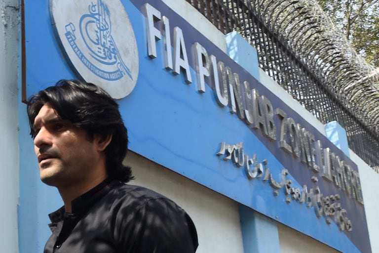 An individual under investigation arrives at the offices of the Federal Investigation Agency (FIA) to record his statement, in Lahore, Pakistan, 20 March 2017, ARIF ALI/AFP via Getty Images