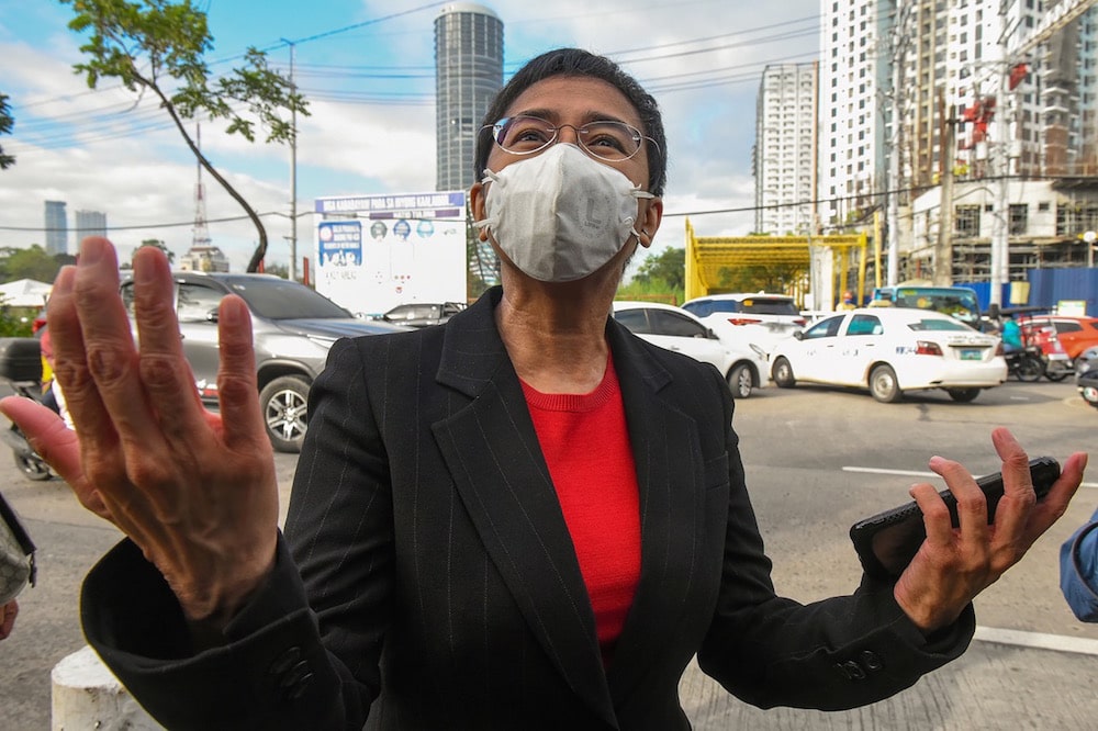 Journalist Maria Ressa speaks to members of the media as she arrives at a court to testify, Manila, Philippines, 4 March 2021, MARIA TAN/AFP via Getty Images