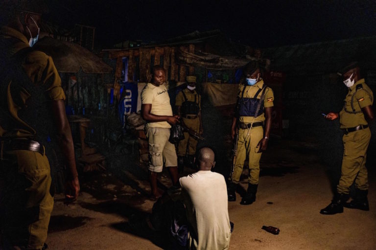 Police officers question a man as they patrol on a street during the curfew to halt the spread of COVID-19, in Kampala, Uganda, 29 April 2020, SUMY SADURNI/AFP via Getty Images