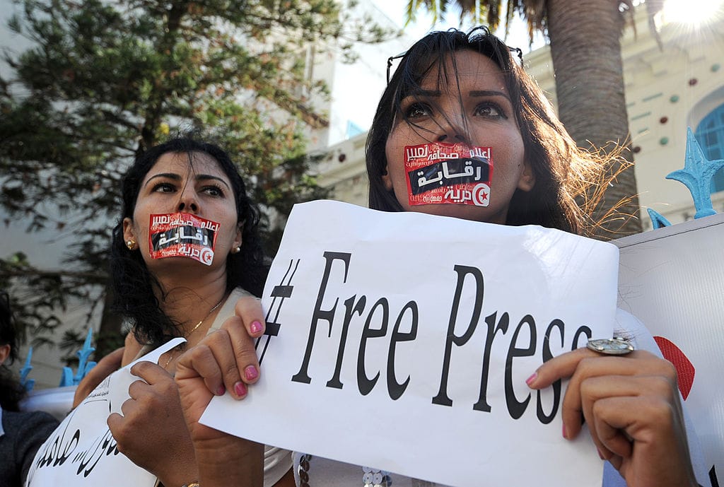 Tunisian journalists protest during a strike in the capital Tunis, on 17 October 2012, after months of rising tensions with the government, which is accused of curbing press freedom and seeking to control public media groups. AFP PHOTO / FETHI BELAID