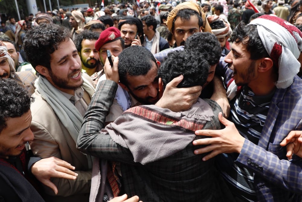 A Yemeni conflict detainee is hugged by his relatives after he was freed in a prisoner exchange between warring sides, at the Sana'a International Airport, Sana'a, Yemen, 16 April 2023. Mohammed Hamoud/Getty Images